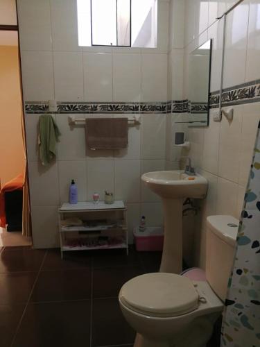 a bathroom with a toilet and a sink at Large quiet apartment in condominium in Santa Eulalia