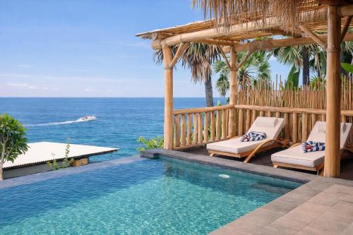 a swimming pool with a gazebo and the ocean at Abing Villas Spa & Beach Bar in Amed