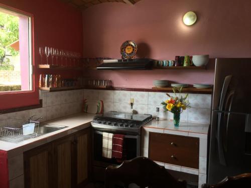 a kitchen with a stove and a sink at Casa Juanita in Sayulita