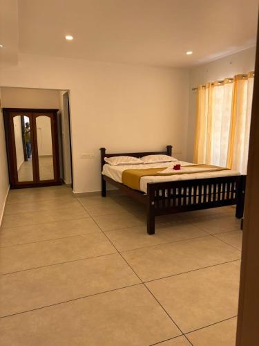 a bedroom with a bed and a mirror in it at Florence Stays Munnar in Munnar