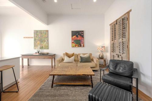 a living room with a couch and a table at Luxury Couples Stay Bangalow l Nova Escapes in Bangalow