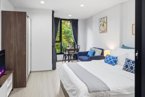 a hotel room with a bed and a tv at Luxury Resort Style 1 Bedroom Studio near Central in Phuket