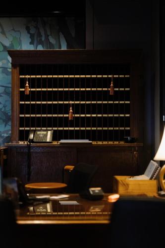an office with a desk with a phone and a lamp at Hotel Woolstore 1888, Sydney - Handwritten Collection in Sydney