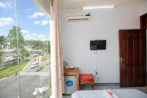 a bedroom with a window with a view of a street at Phú Vang Hotel Pleiku in Pleiku