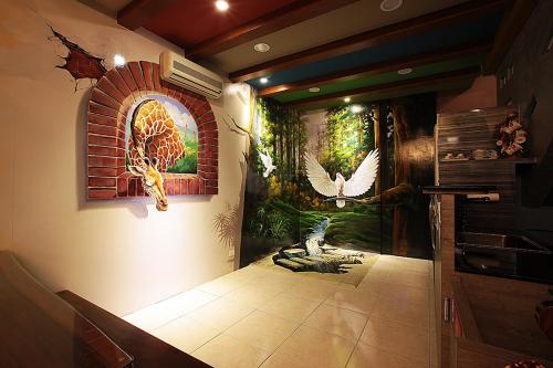 a hallway with a wall with a mural of birds at 3D Sunflower Embossed B&B in Hualien City