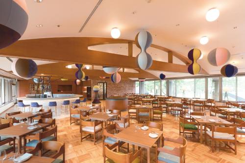 a dining room with wooden tables and chairs at Karuizawa Prince Hotel East in Karuizawa