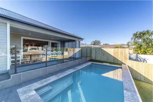 an image of a swimming pool in a house at Capri Waterfront Resort-Style 5BR & Pool in Gold Coast