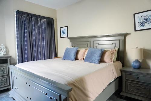 a bedroom with a large bed with blue pillows at Beach, Please MX in Puerto Peñasco