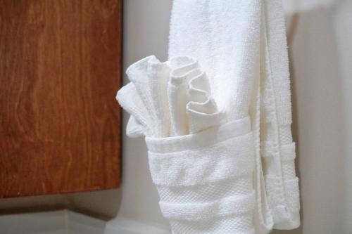 a stack of white towels hanging on a wall at Beach, Please MX in Puerto Peñasco