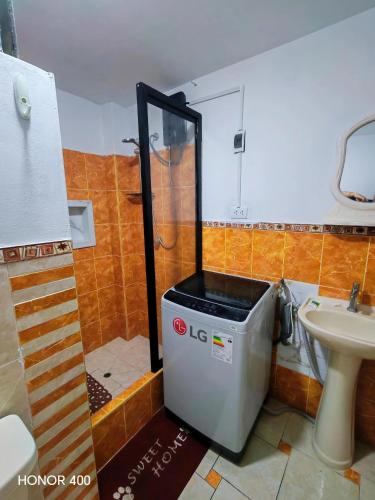 a small bathroom with a shower and a sink at Adel 2 Ovalo Larco Departamento in Trujillo