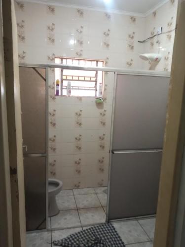 a bathroom with a shower and a toilet in it at Chácara Seu Antônio in Mombuca