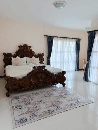 a bed in a bedroom with a rug on the floor at ที่พักสงขลา Homy garden Songkhla in Ban Khao Rup Chang