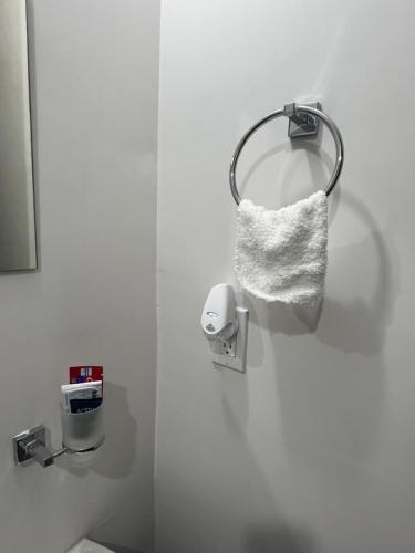 a towel dispenser on a wall in a bathroom at New furnished apartment near BBVA Stadium in Monterrey