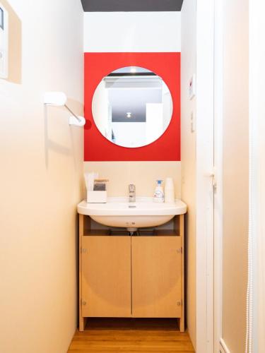 a bathroom with a sink and a mirror at 旅鴉 inn 高松 in Takamatsu