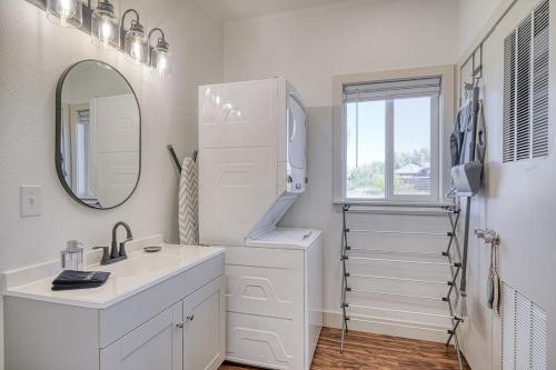 a white bathroom with a sink and a mirror at 2 BR King Bed Hot Tub AC Near Jackson in Victor
