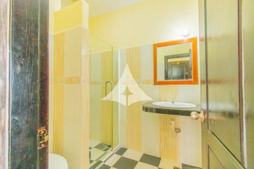 a bathroom with a shower and a sink at Serey Sok San Apartment in Phumi Ta Phul