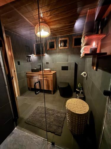 a bathroom with a shower and a table in it at Luxury AFrame with Private Jacuzzi Poás Volcano in Vara Blanca