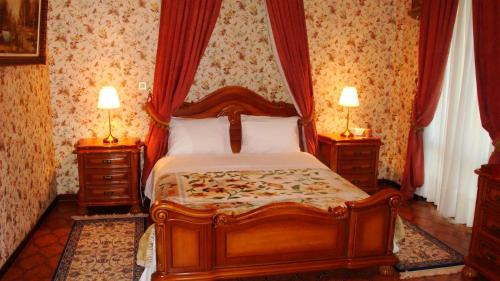 a bedroom with a large bed with two night stands at Castle By The Sea in Artemida