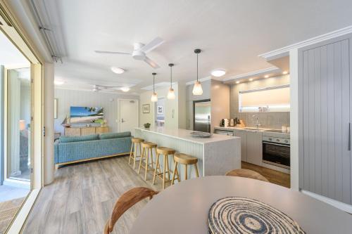 a kitchen and living room with a couch and a table at #2 Hastings Street in Noosa Heads