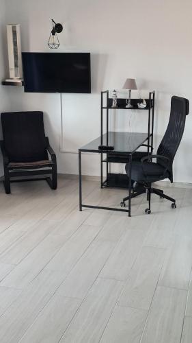 a room with a desk and two chairs and a table at a SPECIAL place in Los Cristianos