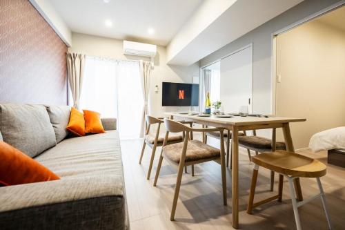 a living room with a couch and a table at Zee Haven nagasakiekimae - ZEE HAVEN長崎駅前 in Nagasaki