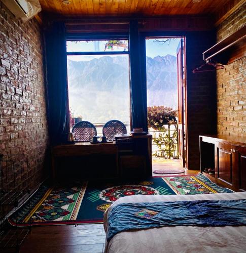 a bedroom with a window with a view of the mountains at Mintu Home in Sapa
