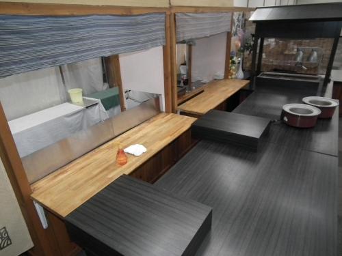 a large room with two benches and a kitchen at Hotel Kadoman in Aso