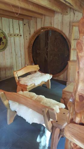a log cabin with two benches and a large barrel at Vientos de Chauquen in Panguipulli