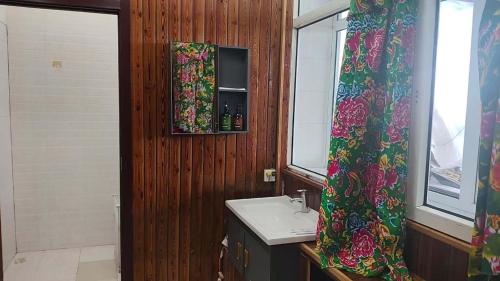a bathroom with a sink and a window at Snow Valley Xishui Dragon Soaring Inn in Wuchang