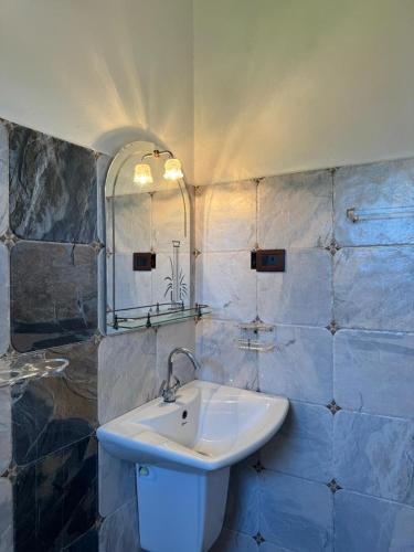 a bathroom with a sink and a mirror at Villa SeaLoom in Galle