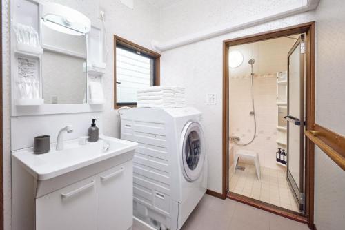 a bathroom with a washing machine and a sink at R STAY Nagoya Atsuta in Nagoya