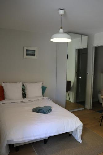 a bedroom with a white bed with a lamp at Studio for 2 people in Bouloc