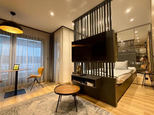 a bedroom with a bed with a large television at Luxe Central Apartments in Budapest