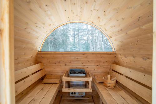 an inside view of a wooden sauna with a window at Foosball table Spa & Sauna - Sommetoile in Saint Come
