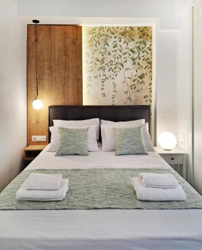 a bedroom with a bed with two towels on it at Blue wave in Ierapetra