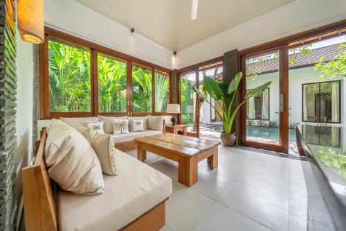 a living room with a couch and a table at Mimosa - Private Pool Escape with Panoramic Views in Kerobokan
