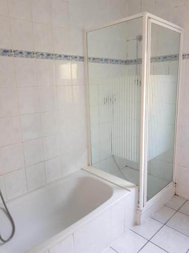 a white bathroom with a tub and a shower at Ferienwohnung Stefanie OG in Bad Breisig