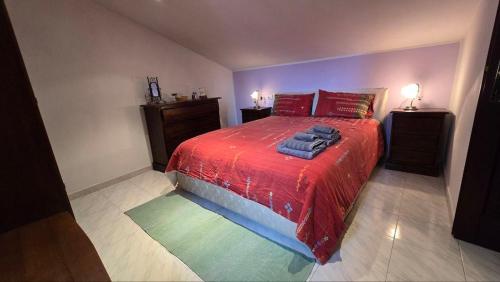 a bedroom with a red bed and two night stands at DaLu' tourist accommodation in Vallerano