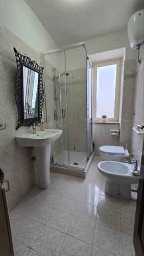 a bathroom with a sink and a tub and a shower at DaLu' tourist accommodation in Vallerano