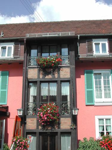 a building with flower boxes on the side of it at Gasthaus-Pension Zum Kreuz in Stühlingen