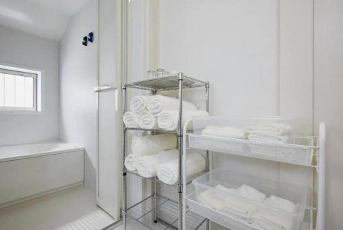 a bathroom with a rack of toilet paper at koiwa house 3LDK free wifi free parking in Tokyo