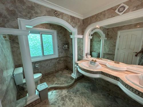 a large bathroom with a sink and a mirror at Breakfast at Monaco - Palais Boracay in Boracay