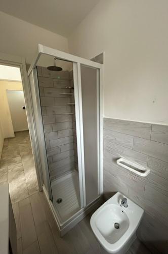 a bathroom with a shower and a toilet and a sink at Appartamento LiboMarì in Favignana