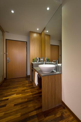 a bathroom with a sink and a large mirror at Howard Plaza Hotel Hsinchu in Hsinchu City