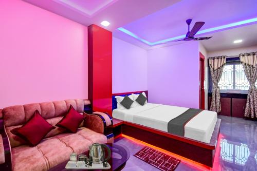 a bedroom with a bed and a couch at Hotel O THE CROWN COMFORTS in Kolkata