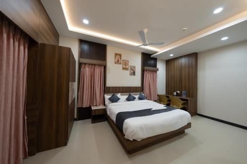 a bedroom with a large bed and a screen at Le Sea Sun in Pūrnānkuppam
