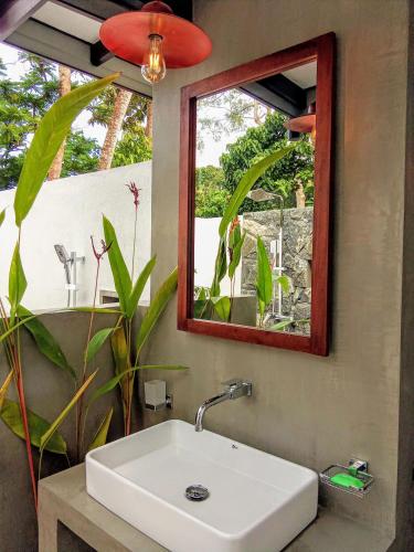 a bathroom with a sink and a mirror at Subhasha Summer House in Talalla South