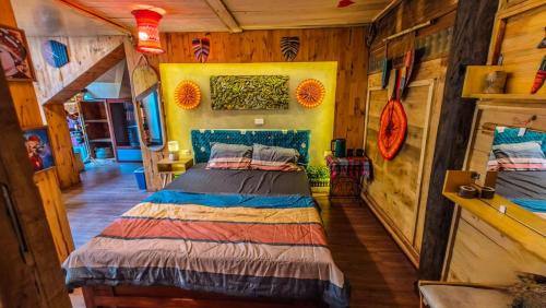 a bedroom with a bed in a room with wooden walls at Oáza coffee & bar in Hanoi