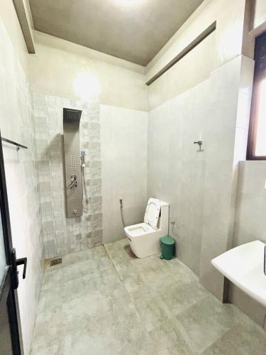 a bathroom with a toilet and a sink at Ceylan Dream Hiriketiya in Nilwella