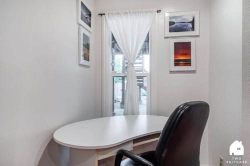a white table and a black chair in a room at Cozy Charming Richmond 1BR Retreat in San Francisco